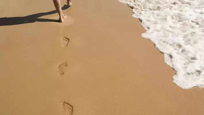 footprints on the sandy beach